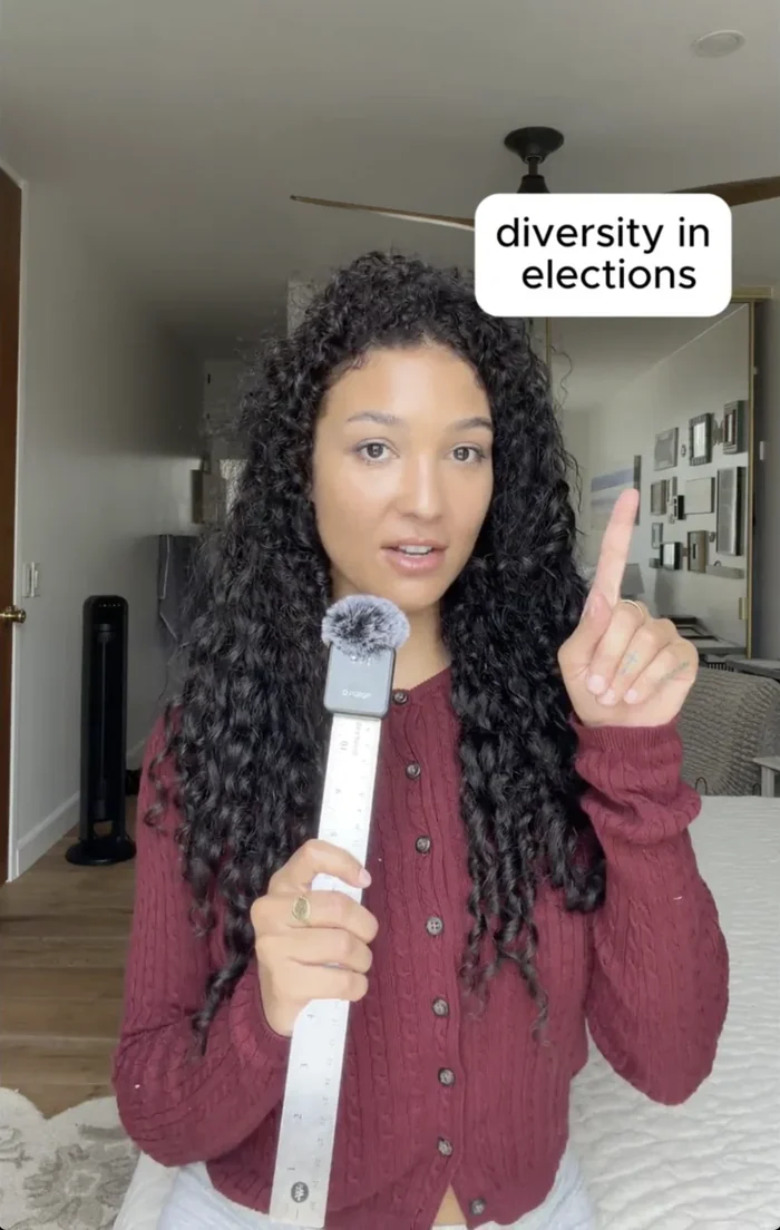 A finished vertical video: a woman speaking to camera, with an on-screen caption reading “diversity in elections.”